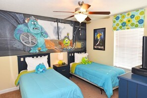Cozy retreat with two single beds, a wall-mounted TV, and a ceiling fan.