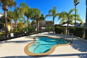 Guests can enjoy a refreshing swim in the resort's oval-shaped pool surrounded by a deck.