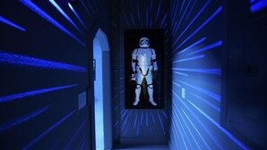 A corridor with a Star Wars Stormtrooper figure in the center, surrounded by blue light effects. - 394 Watersong House 6 Bedroom by Florida Star (Davenport)