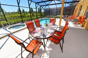 Relax in style with a dining area and hot tub overlooking the surrounding landscape.