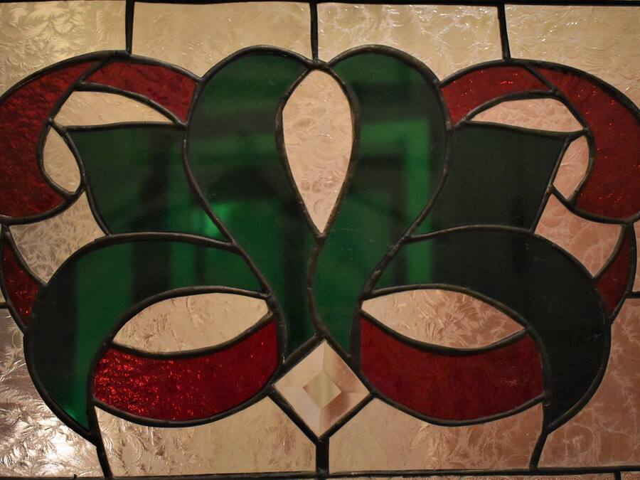 A stained glass window with a floral design.