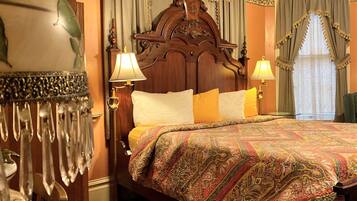 A traditional bed with a wooden headboard, two bedside lamps, and a patterned bedspread.
