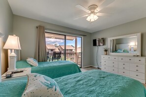 A hotel room with two beds, a ceiling fan, a TV, a dresser, and a balcony with a view. - Anchorage Abode I A09 2 Bedroom Condo by Anchorage (Myrtle Beach)