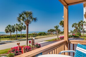 A balcony with a view of the beach, palm trees, and a road. - Anchorage Abode I A09 2 Bedroom Condo by Anchorage (Myrtle Beach)