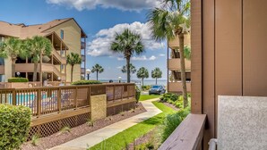 A resort with a pool, palm trees, and a view of the ocean. - Anchorage Abode I A02 2 Bedroom Condo by Anchorage (Myrtle Beach)