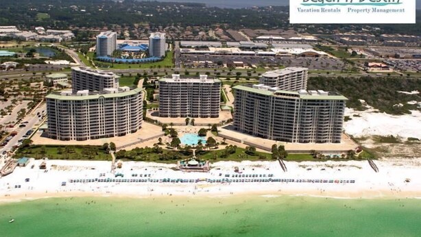 A resort with three circular buildings, a central pool, and a beach. - St Croix at Silver Shells 3 Bedroom Apartment by BnD (Destin)