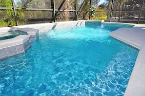 A swimming pool with a hot tub and a covered area. - 152 The Shires House 5 Bedroom by Florida Star (Davenport)