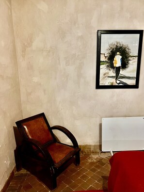 A room with a chair, a whiteboard, and a framed painting on the wall. - Les Sources Berbères Riad & Spa (Marrakech)