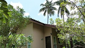A two-story building with a brown facade, a visible door, and windows. - Bann Suan Rachawadee B&B (Sisaket)