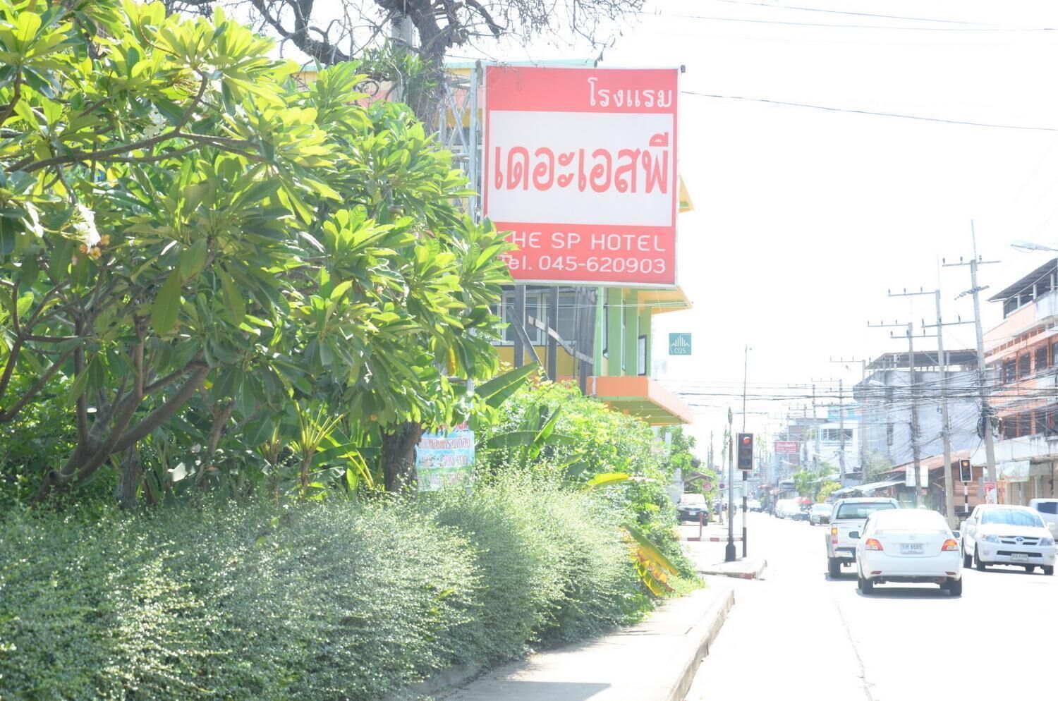 Señal de hotel con texto en tailandés y un número de contacto.