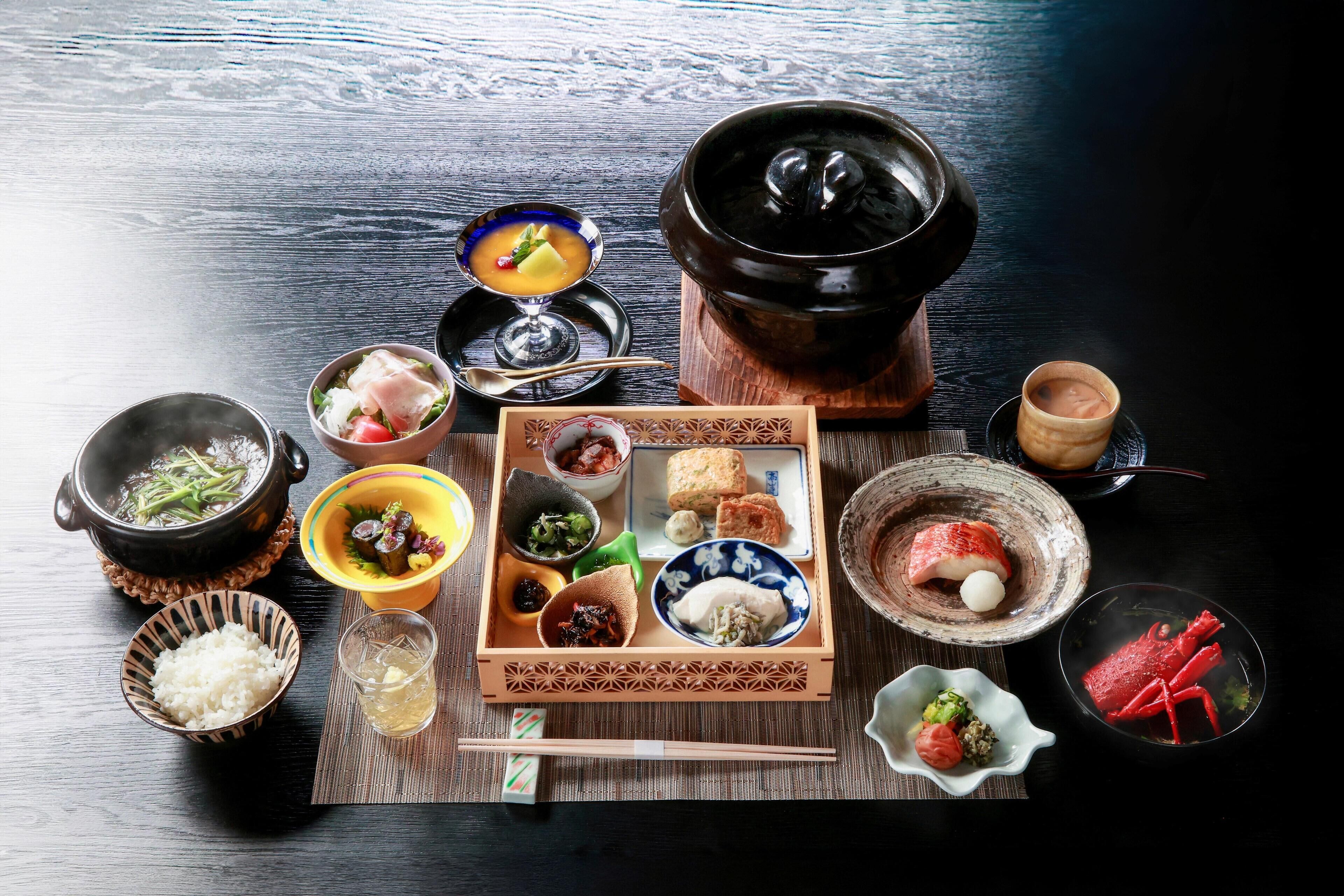A traditional Japanese meal setup with various dishes and a hot pot.