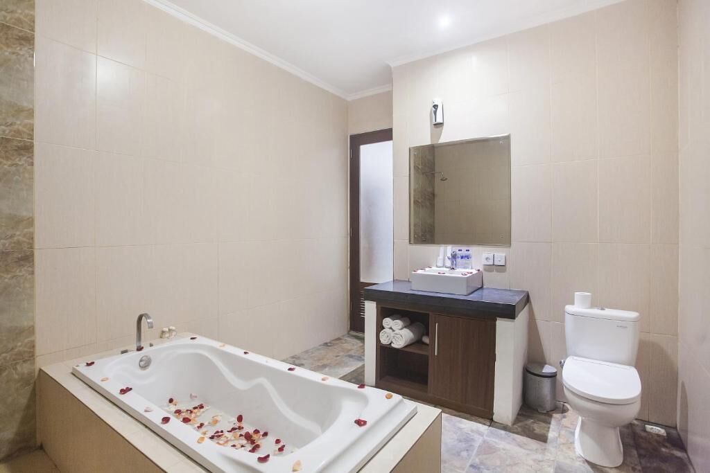 A modern bathroom with a freestanding bathtub, a sink, and a toilet.