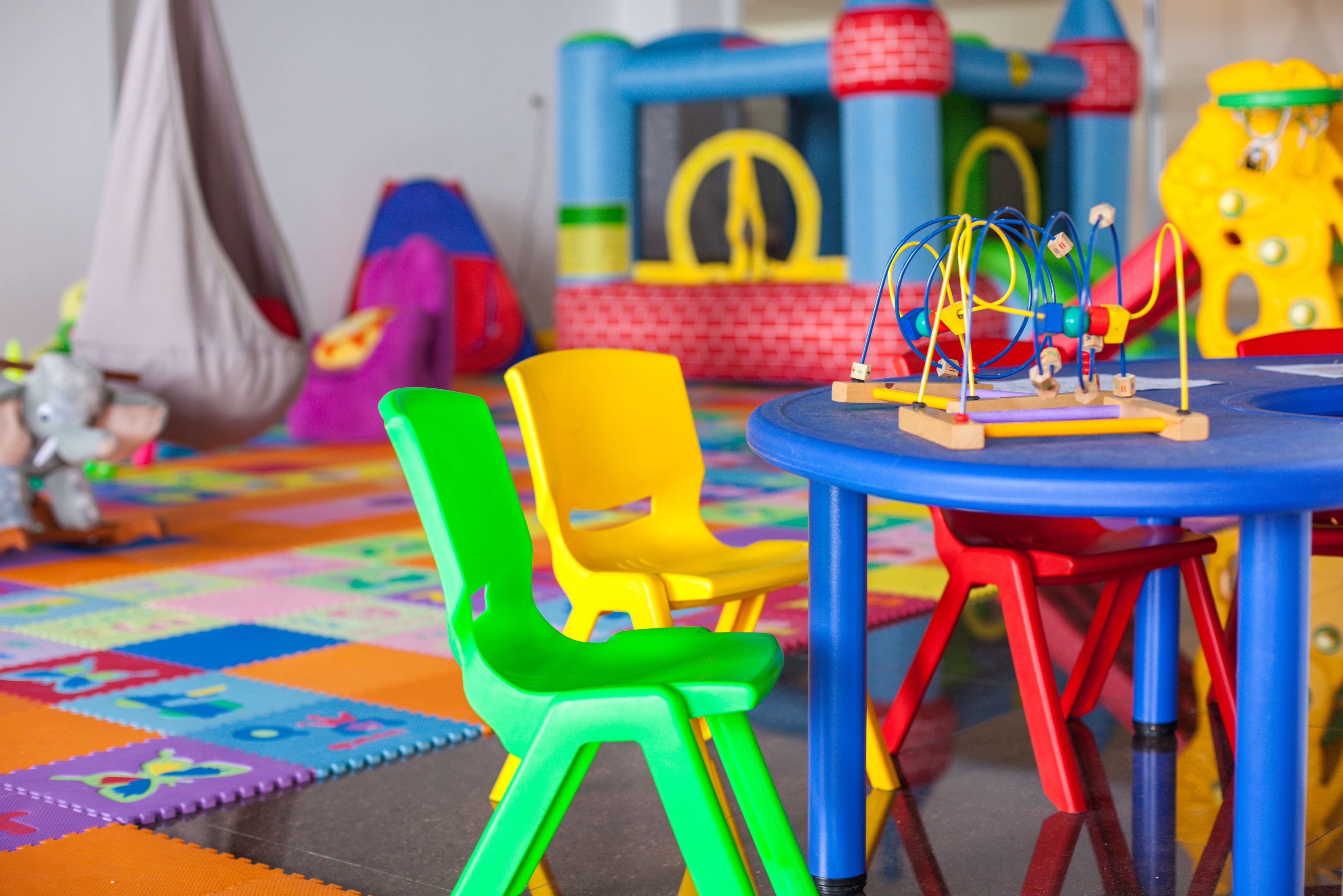 A play area with colorful chairs and a small table.