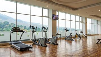 A gym with treadmills, elliptical machines, and stationary bikes.