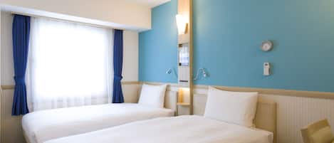 A hotel room with two beds, a large window with curtains, a wall-mounted heater, and a clock.