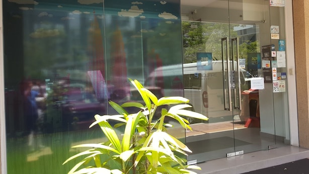 A building entrance with a glass door, a push bar, and a sign indicating no pets allowed. - 9 Square Hotel - Kota Damansara (Petaling Jaya)