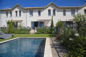 Enjoy a refreshing dip in the large pool surrounded by lush gardens and comfortable outdoor seating areas.