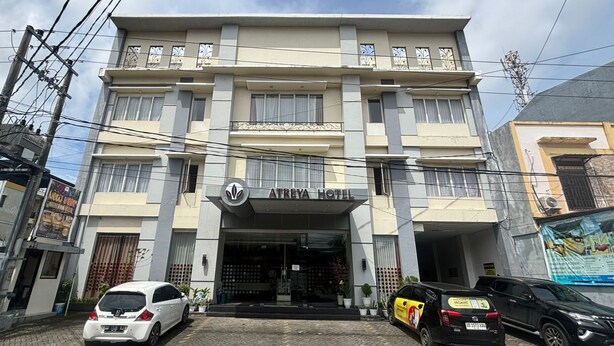 A hotel with a modern facade, multiple balconies, and a prominent entrance. - Atreya Hotel Makassar (Makassar)