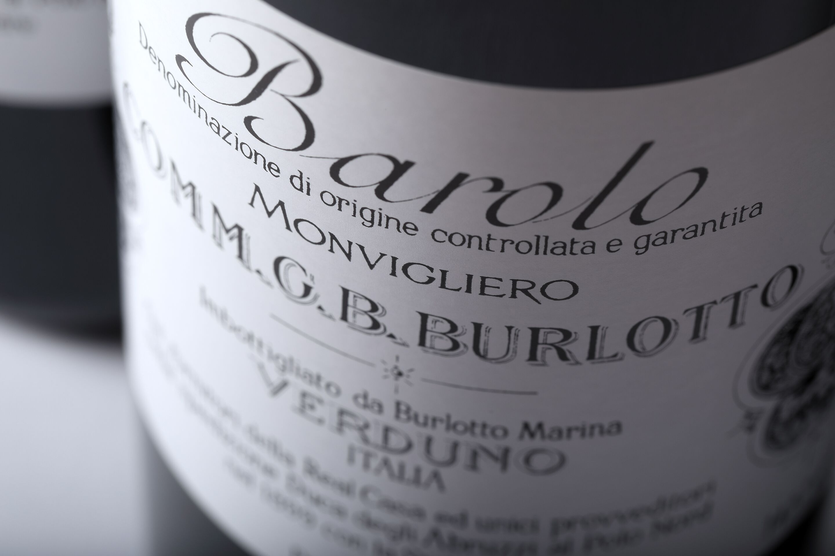 A wine label with the name "Barolo" and "M.G.B. Burlotto" prominently displayed.