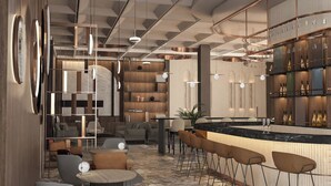 A modern bar area with a marble countertop, bar stools, and a variety of lighting fixtures. - voco Katowice by IHG (Katowice)