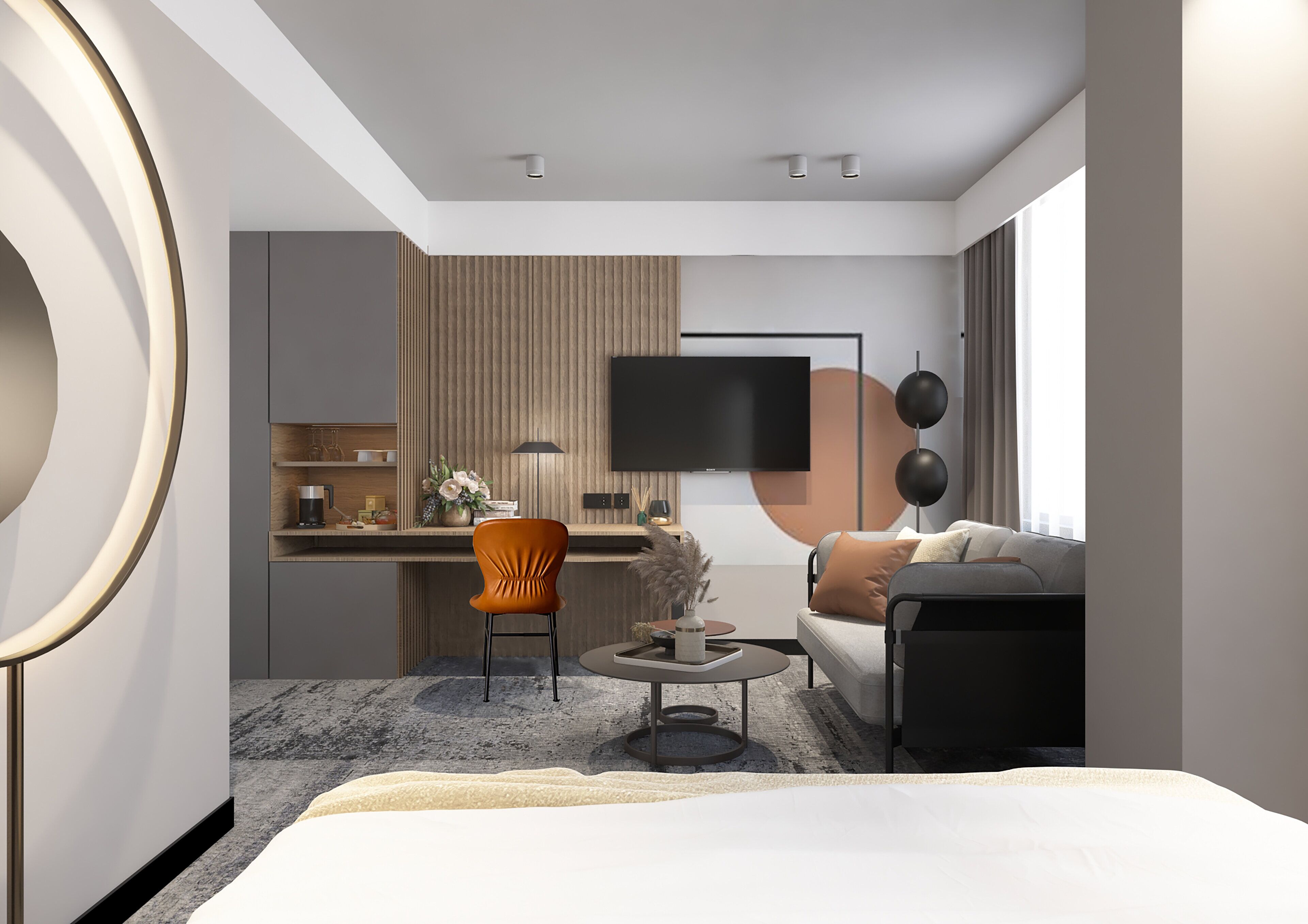 A modern hotel room with a bed, a sofa, a dining area, and a TV.
