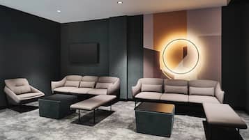 A modern living room with a sectional sofa, a chaise lounge, and a coffee table.