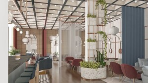 A modern interior with a wooden floor, seating areas, and a vertical plant installation. - voco Katowice by IHG (Katowice)
