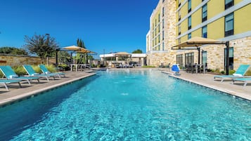 Outdoor pool, open 10:00 AM to 10 PM, pool umbrellas, pool loungers