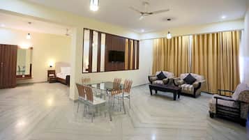 Luxury Suite, Lake View | Living area | 32-inch LED TV with cable channels