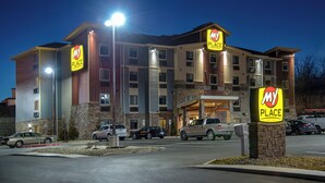 A multi-story hotel with 'My Place' signage, a parking lot, and a well-lit entrance. - My Place Hotel - Kansas City East/Independence, MO (Independence)