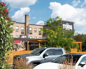 A building with a mural and a sign that reads "The Oxbow."