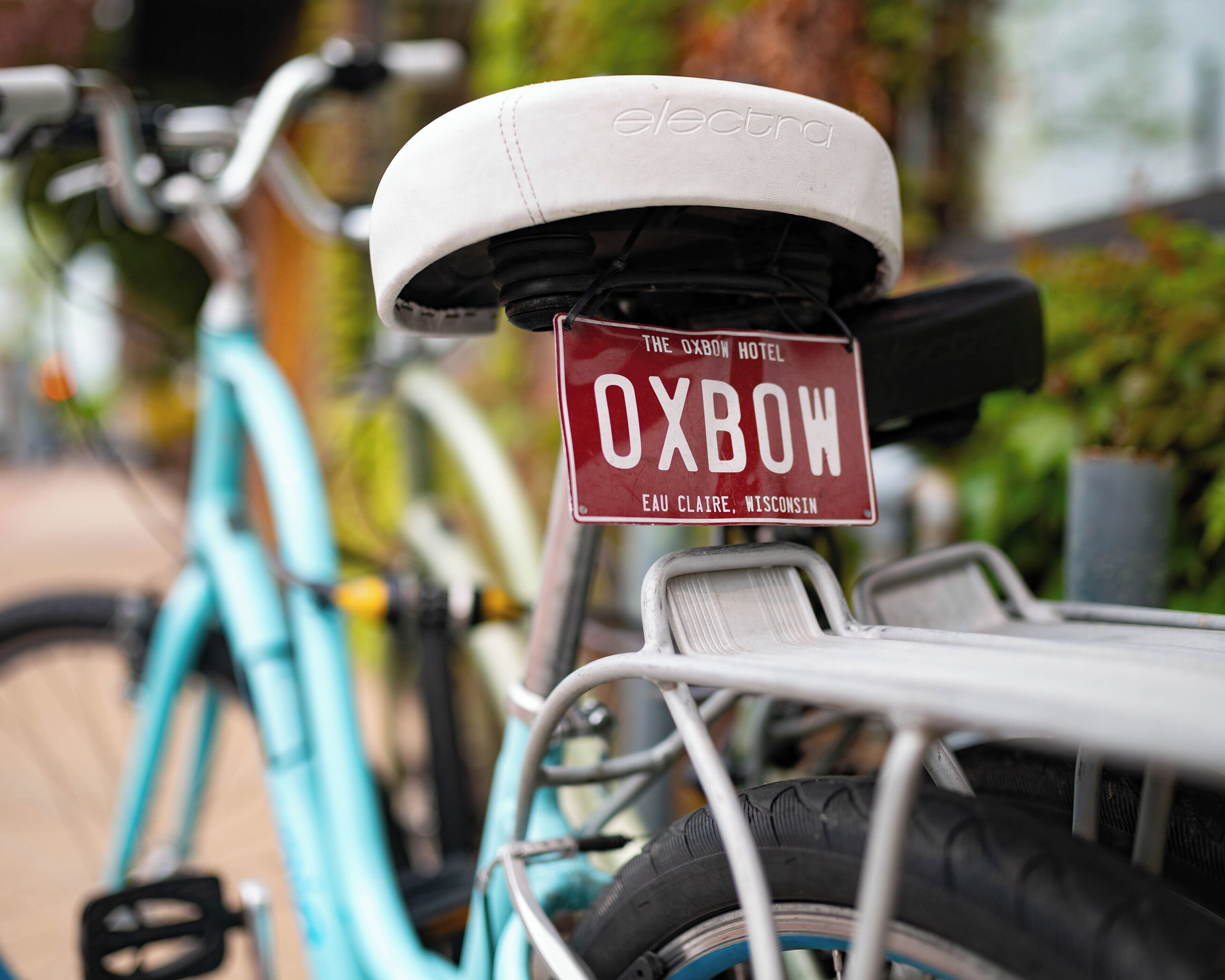 A bicycle with a sign that reads "Oxbow Hotel Eau Claire, Wisconsin."