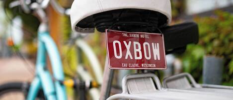 A bicycle with a sign that reads "Oxbow Hotel Eau Claire, Wisconsin."