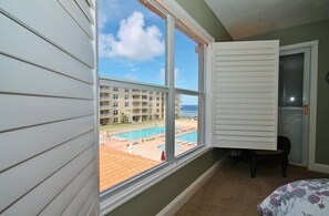 Enjoy a serene view of the pool and complex from this room's large window.