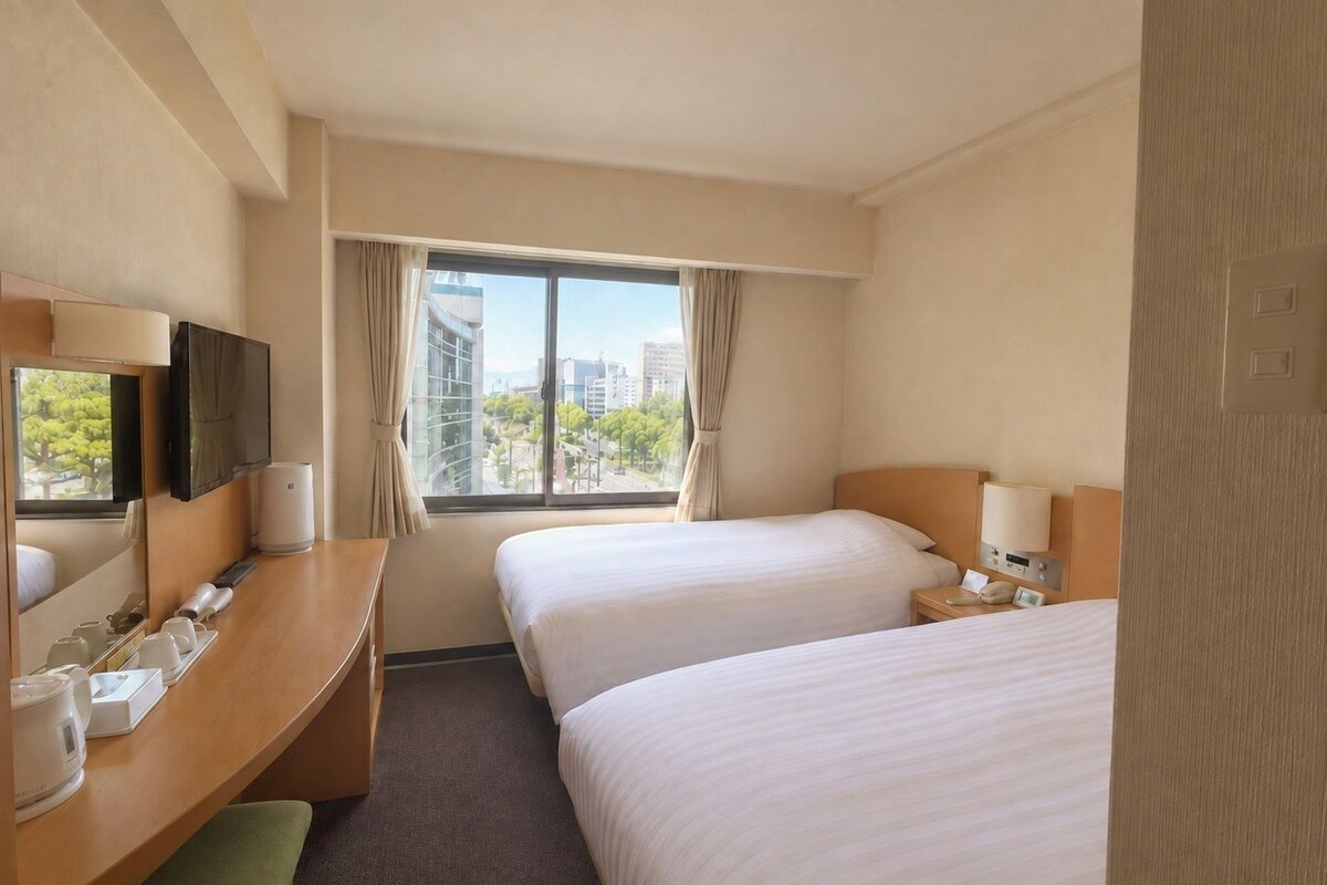 A hotel room with two beds, a desk with a mirror, a television, and a window with a city view.
