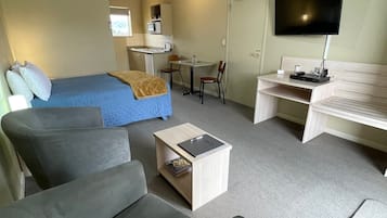 Deluxe Studio Apartment | Living area | LCD TV, DVD player