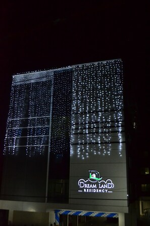 A building with a large illuminated sign reading "Dream Land Residency." - Dream Land Residency (Mananthavady)