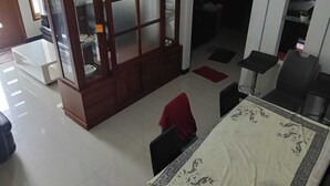 Un comedor con una mesa, sillas y un aparador con puertas de vidrio.