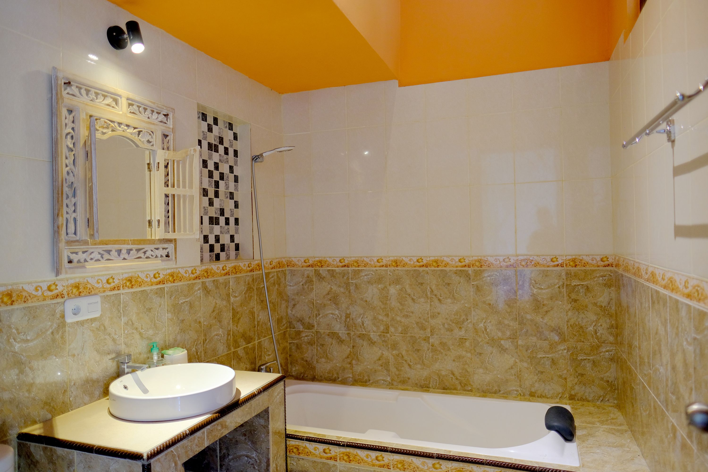 A bathroom with a bathtub, a sink, and a mirror.