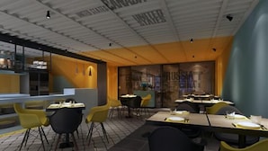 A modern restaurant with a high ceiling, yellow chairs, and tables set for dining. - Iway International Holiday Apartment (Guangzhou)