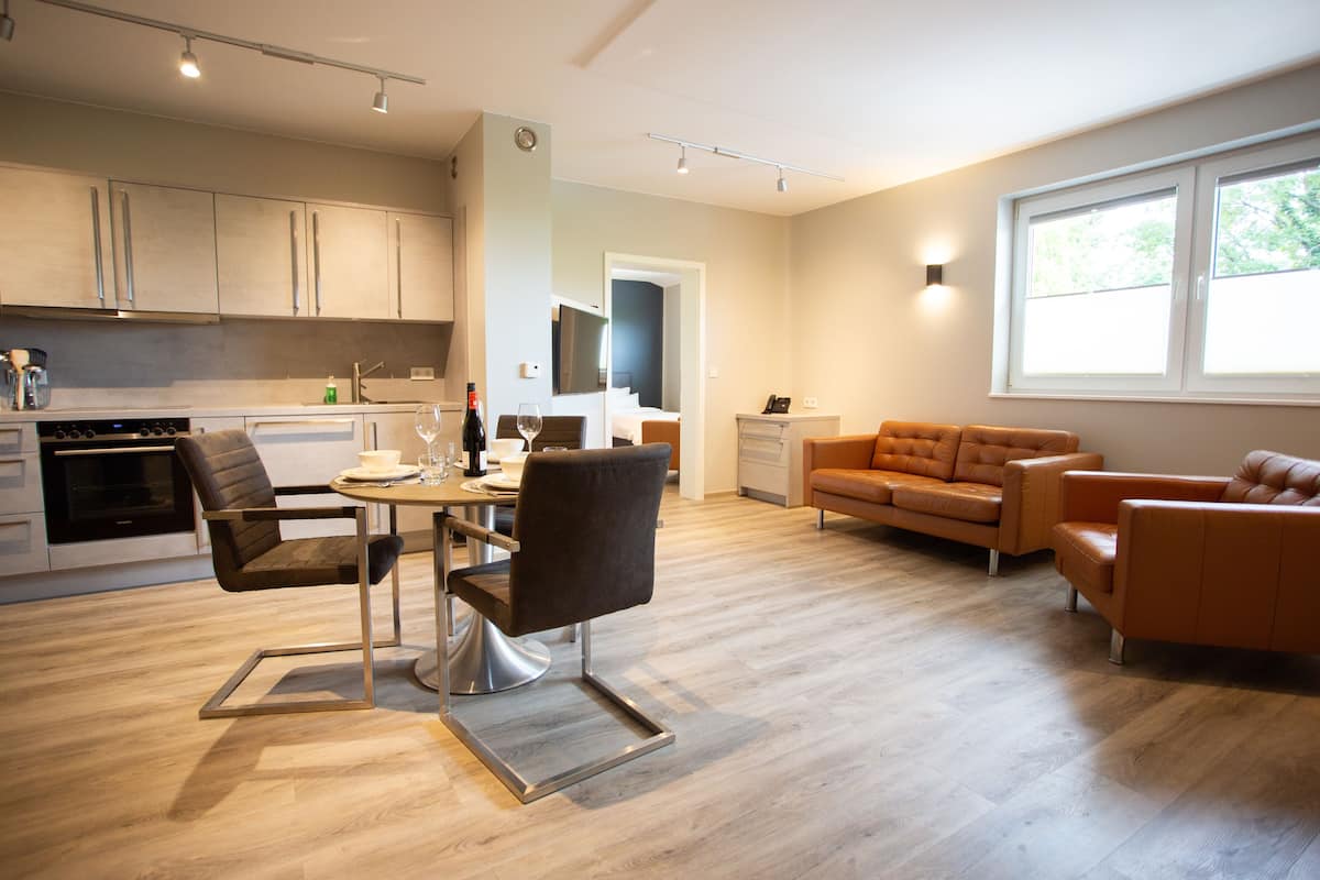 deluxe apartment | living area | 40-inch flat-screen tv with satellite channels, tv, netflix