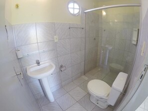 Bathroom features a pedestal sink, toilet, and glass shower enclosure.
