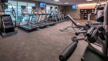 A gym with treadmills, ellipticals, and weight machines.