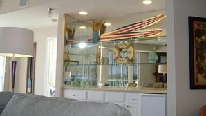 A room with a bed, a mirror, and a shelf with various items. - Towers 9106 4 Bedroom Condo by Your Lake vacation (Osage Beach)