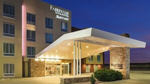 A Fairfield Inn & Suites Marriott hotel with a covered entrance, stone pillar, and a well-lit facade. - Fairfield Inn & Suites by Marriott Sidney (Sidney)