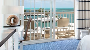 A hotel room with a balcony overlooking a marina and the ocean. - Hilton Key West Resort & Marina (Key West)