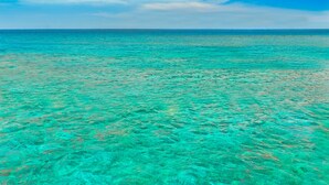 A clear view of turquoise ocean water and a blue sky with clouds. - Hilton Key West Resort & Marina (Key West)