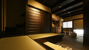 A tatami mat room with a low table, a sliding door, and a view of the outside. - Kuraya Omiya-Shimabara (Kyoto)