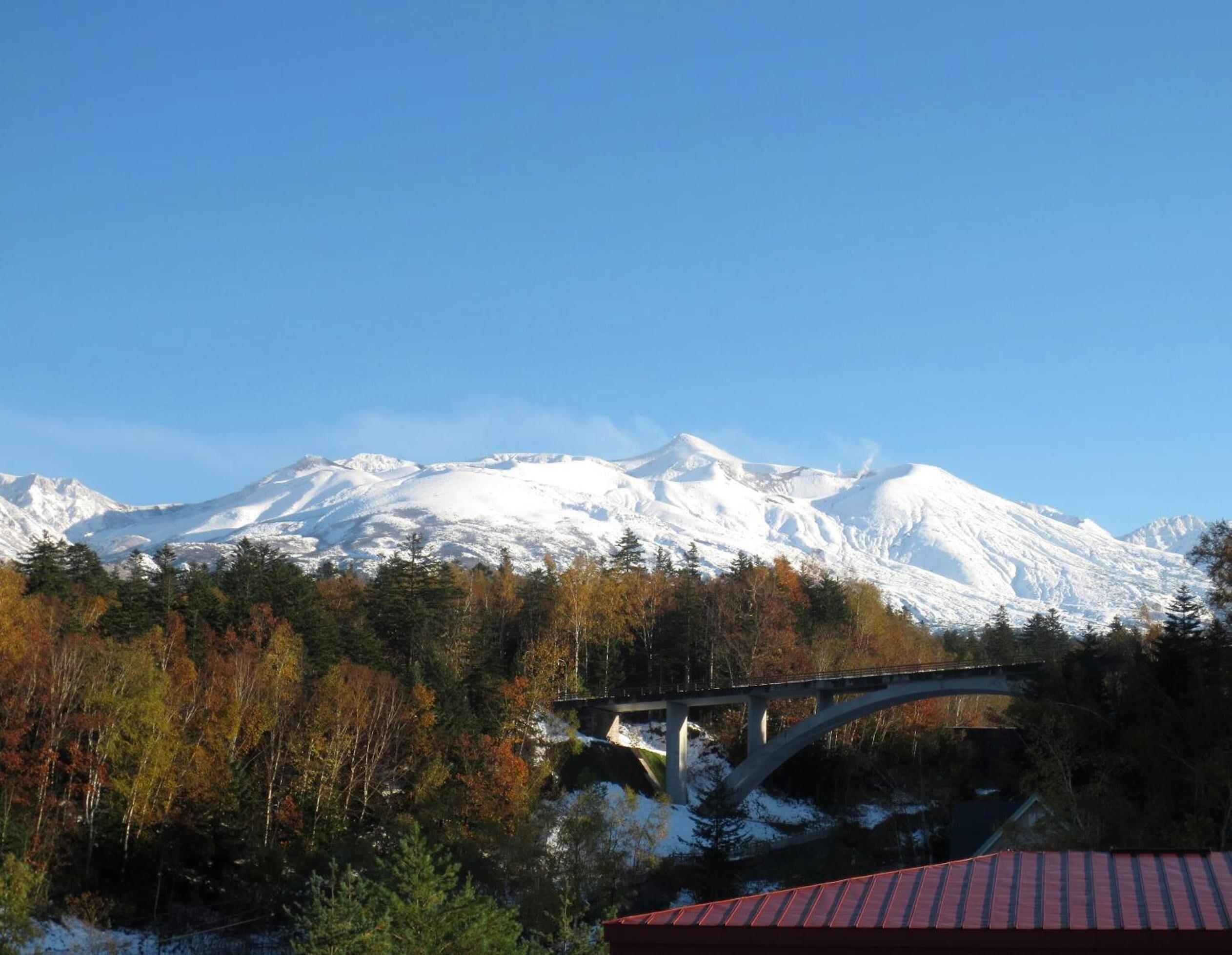 A mountain range with a bridge in the foreground.
