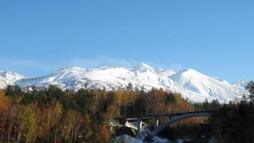 A mountain range with a bridge in the foreground.